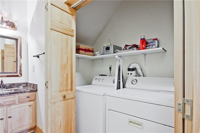 laundry area with laundry area, washing machine and dryer, and a sink