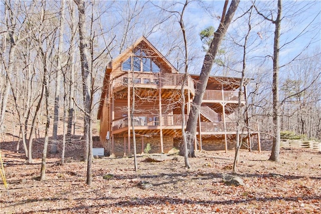 exterior space featuring stairway and a wooden deck