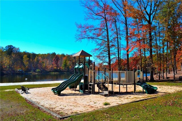 community jungle gym featuring a water view and a wooded view