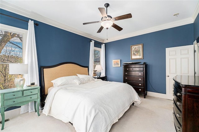 bedroom with crown molding, light colored carpet, and ceiling fan