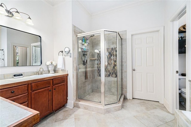 bathroom with tile patterned flooring, ornamental molding, vanity, walk in shower, and toilet