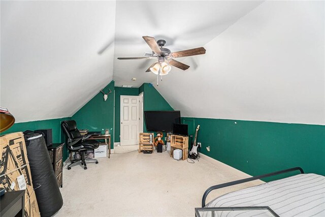 office space with vaulted ceiling, ceiling fan, and carpet