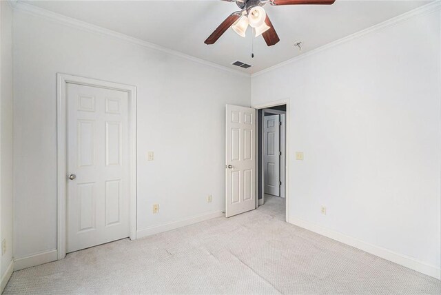 unfurnished bedroom with light carpet, crown molding, and ceiling fan