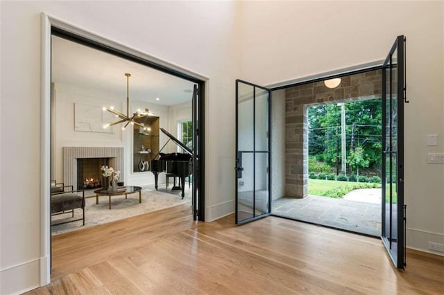 entryway featuring hardwood / wood-style floors and a notable chandelier