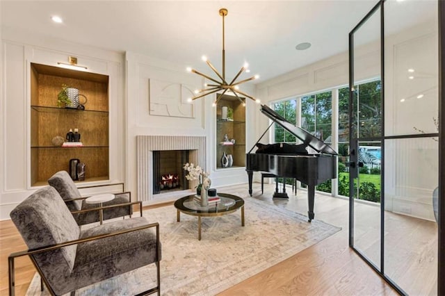 living area featuring a chandelier and light wood-type flooring