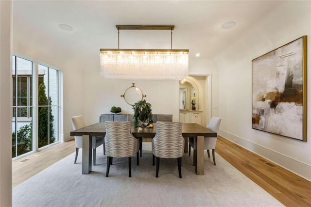 dining room with a chandelier and hardwood / wood-style flooring