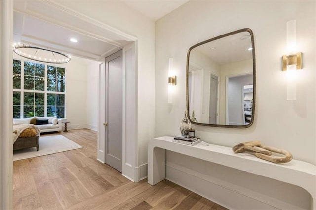 bathroom with hardwood / wood-style floors and a notable chandelier