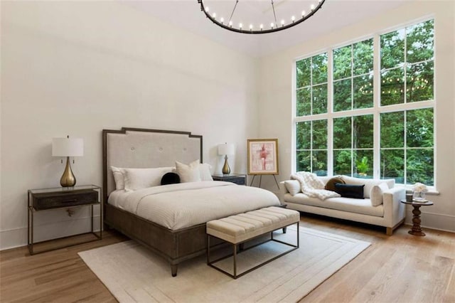 bedroom featuring light hardwood / wood-style flooring and a notable chandelier