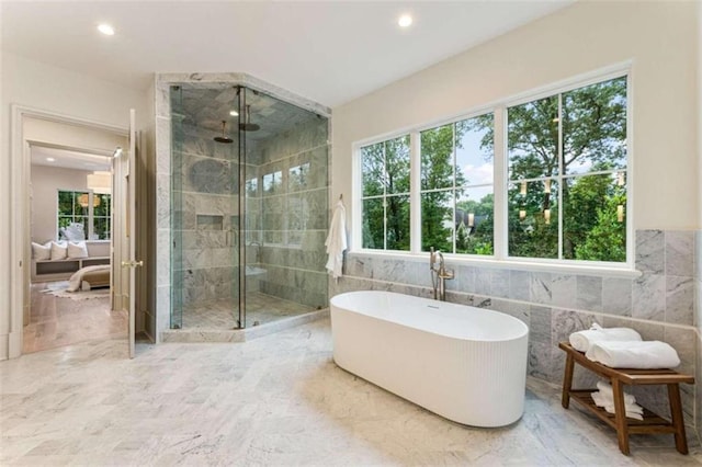 bathroom with plus walk in shower and tile walls