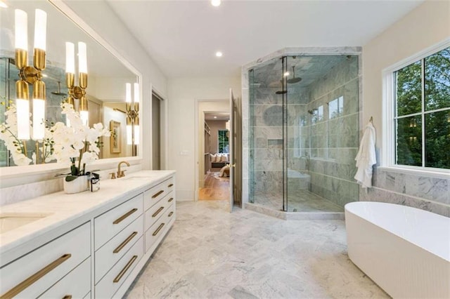 bathroom with vanity, a healthy amount of sunlight, and shower with separate bathtub