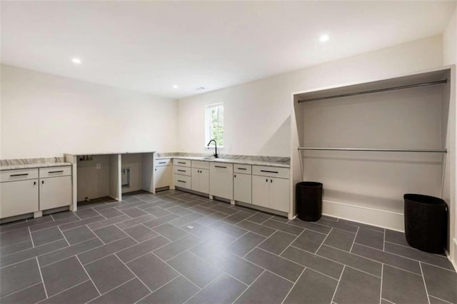 washroom with dark tile patterned floors and sink