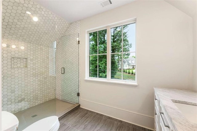 bathroom featuring walk in shower, vanity, lofted ceiling, and toilet