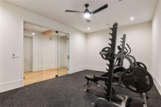 workout room featuring hardwood / wood-style flooring and ceiling fan