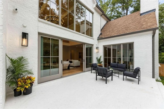 rear view of house with an outdoor hangout area and a patio