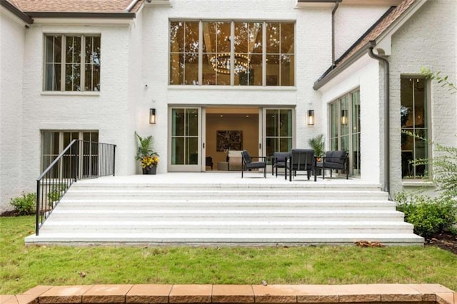 rear view of property with outdoor lounge area