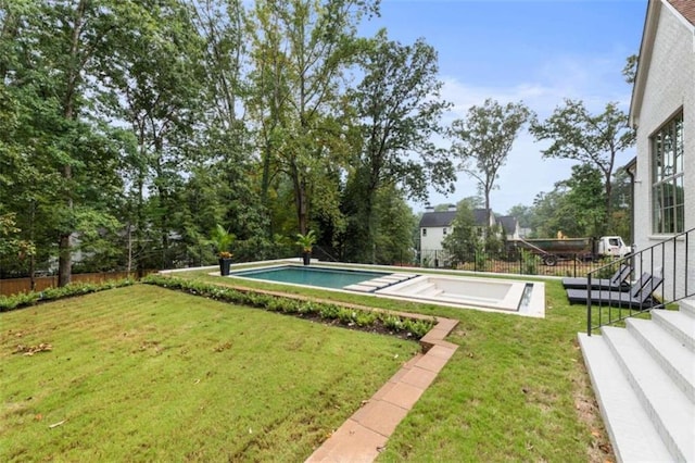 view of swimming pool with a lawn