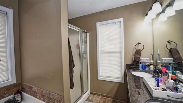 bathroom with double vanity, a bathing tub, a shower stall, and a sink