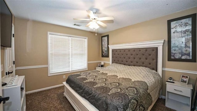 bedroom featuring ceiling fan, baseboards, visible vents, and dark colored carpet