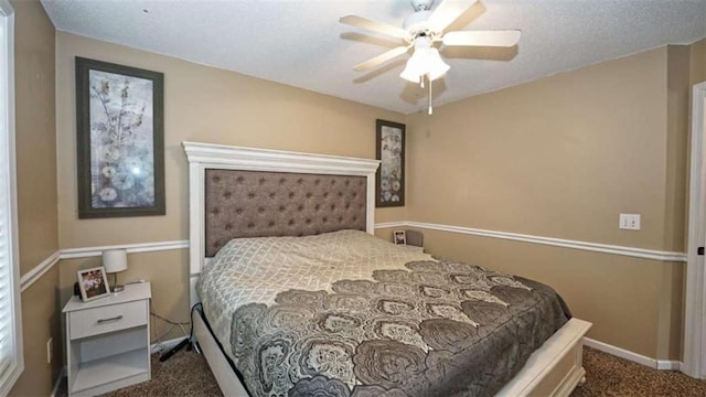 bedroom featuring carpet, a textured ceiling, baseboards, and a ceiling fan