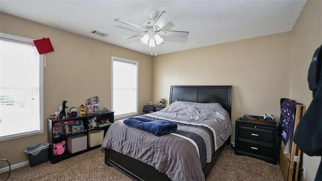 bedroom featuring ceiling fan, carpet flooring, visible vents, and baseboards