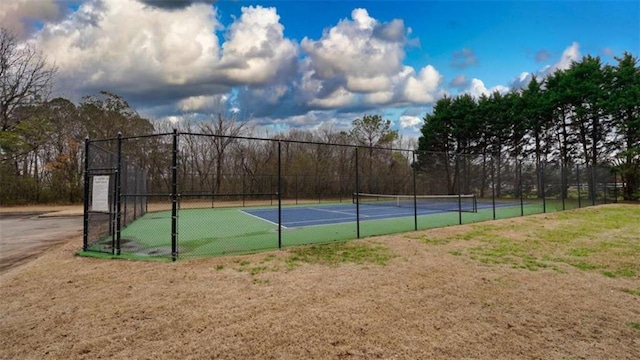 view of sport court featuring fence