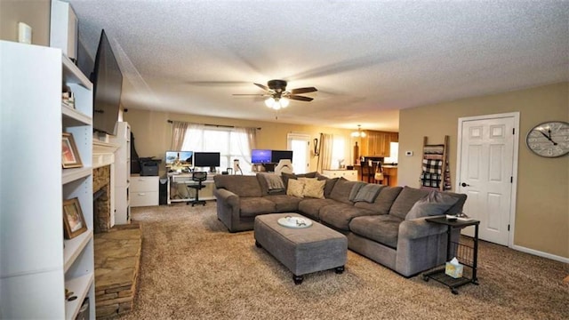 living room with a fireplace with flush hearth, carpet, ceiling fan, and a textured ceiling