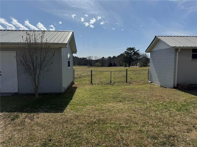 view of yard featuring an outdoor structure and fence