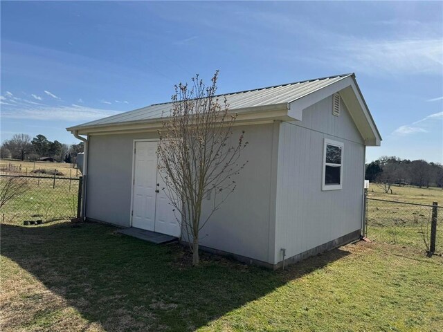 view of outbuilding featuring fence and an outdoor structure