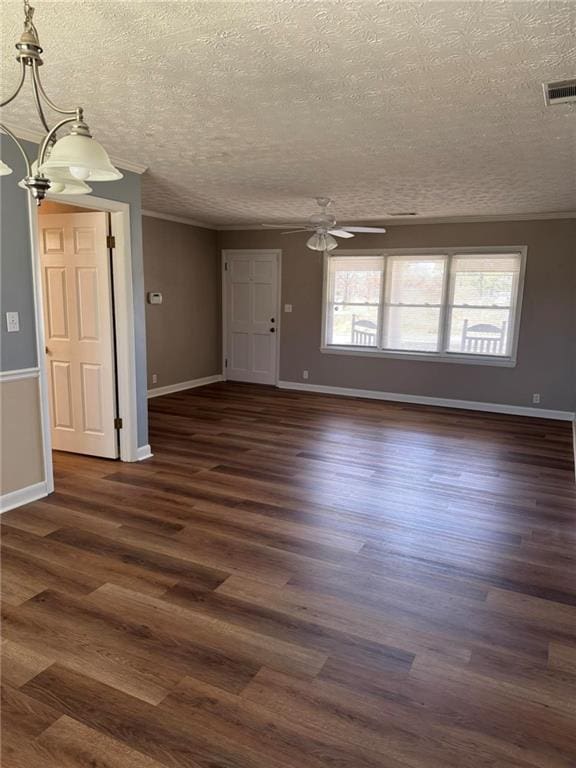 unfurnished room featuring baseboards, visible vents, dark wood finished floors, a textured ceiling, and ceiling fan with notable chandelier