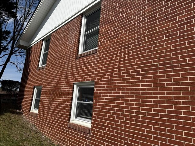 view of side of home with brick siding