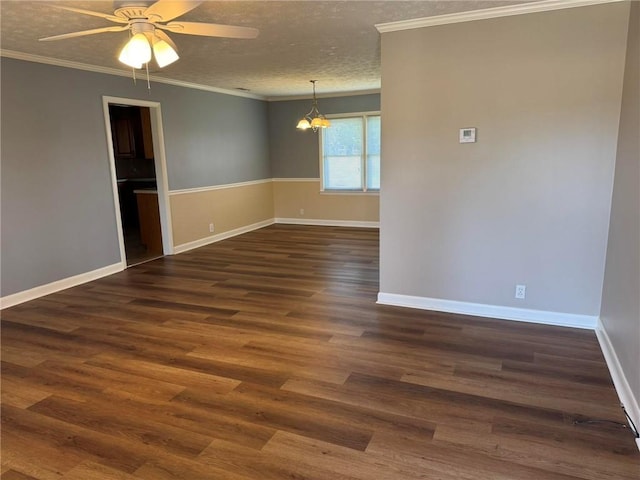 unfurnished room featuring a textured ceiling, ornamental molding, and dark wood finished floors