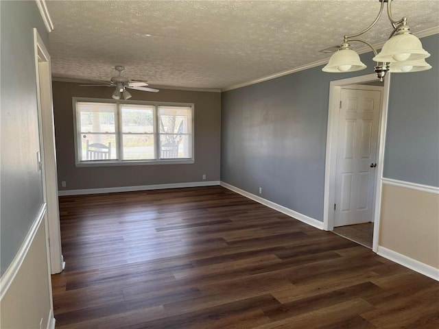 empty room with baseboards, a textured ceiling, ornamental molding, and dark wood-style flooring