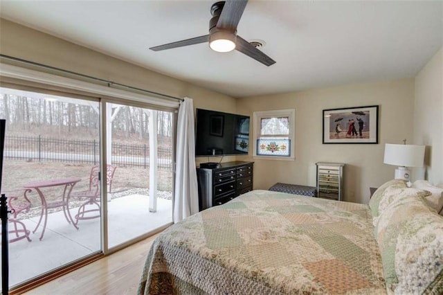 bedroom featuring access to outside, light hardwood / wood-style floors, and ceiling fan