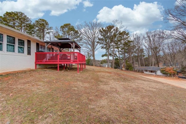 view of yard with a wooden deck and a gazebo