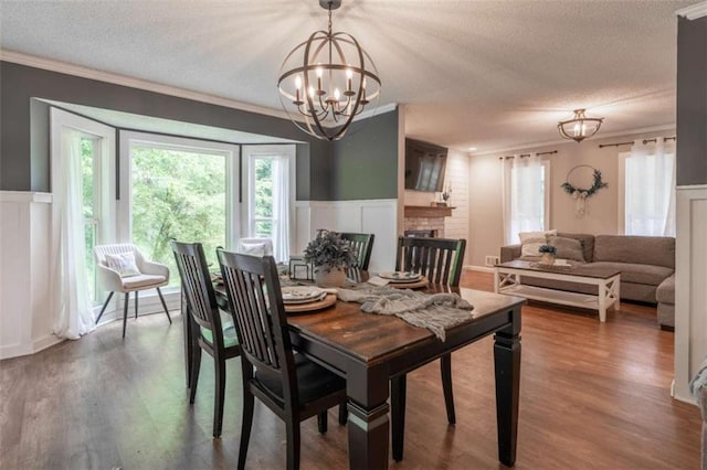 361 Princeton Way, Lawrenceville, GA 30044 - dining space with a textured ceiling, a chandelier, crown molding, a decorative wall, and wood finished floors