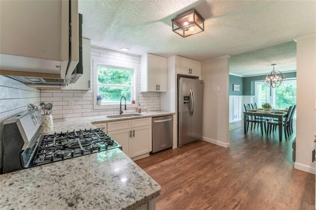 361 Princeton Way, Lawrenceville, GA 30044 - kitchen featuring stainless steel appliances, a textured ceiling, healthy amount of natural light, decorative backsplash, and white cabinetry