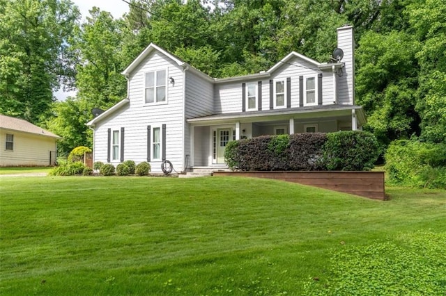 361 Princeton Way, Lawrenceville, GA 30044 - view of front of house featuring a chimney, a front lawn, covered porch, and view of wooded area