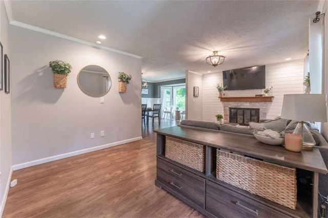 361 Princeton Way, Lawrenceville, GA 30044 - living room with ornamental molding, wood finished floors, a brick fireplace, and recessed lighting