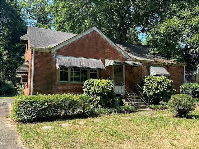 bungalow-style house with a front lawn