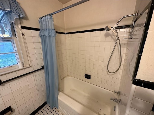 bathroom featuring tile patterned flooring and shower / bath combo