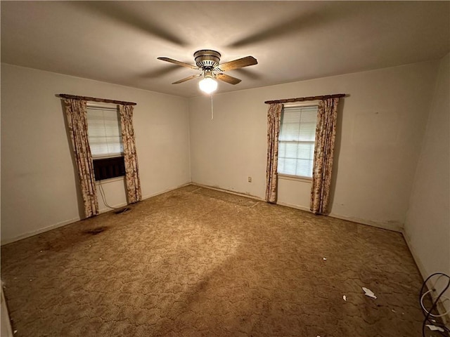 carpeted spare room featuring ceiling fan