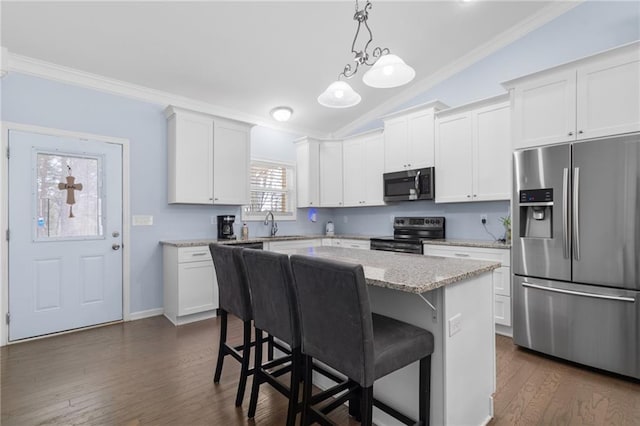 541 Mulberry Cir, Jasper, GA 30143 - kitchen featuring appliances with stainless steel finishes, white cabinetry, a kitchen island, hanging light fixtures, and a breakfast bar area