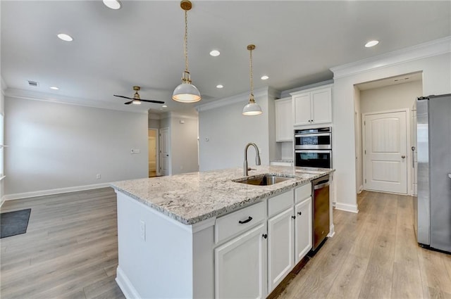 2090 Harvester Ln, Buford, GA 30518 - kitchen with appliances with stainless steel finishes, crown molding, a kitchen island with sink, white cabinets, and light wood-style flooring