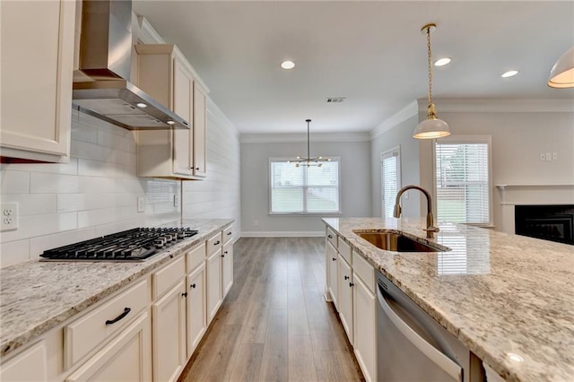 2090 Harvester Ln, Buford, GA 30518 - kitchen featuring wall chimney exhaust hood, stainless steel appliances, light wood-type flooring, crown molding, and tasteful backsplash