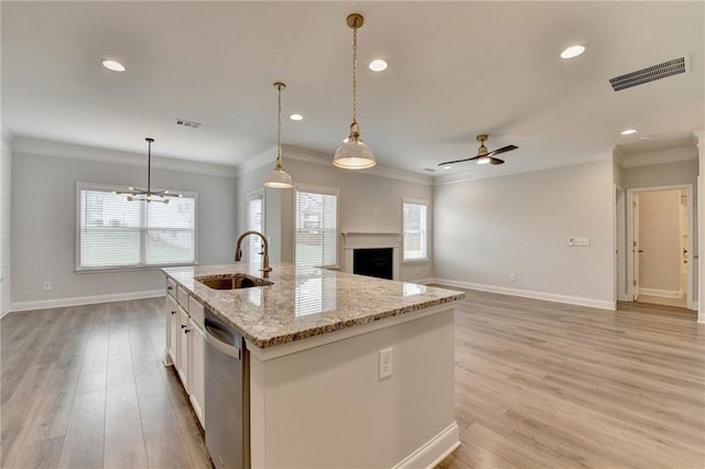 2090 Harvester Ln, Buford, GA 30518 - kitchen featuring stainless steel dishwasher, a fireplace, white cabinets, recessed lighting, and a center island with sink