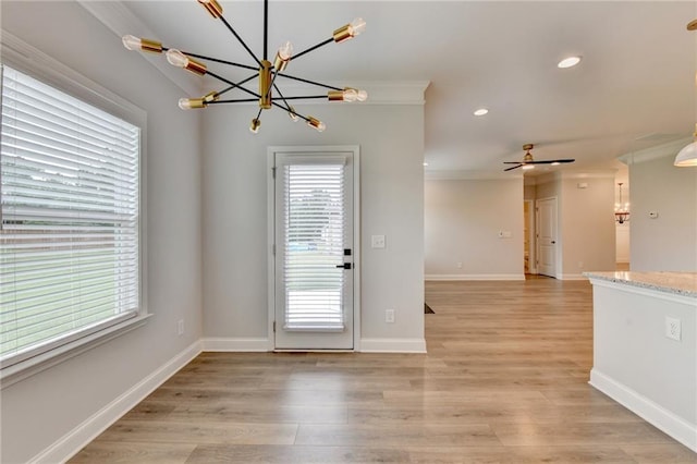 2090 Harvester Ln, Buford, GA 30518 - unfurnished dining area with a chandelier, recessed lighting, crown molding, light wood-type flooring, and ceiling fan