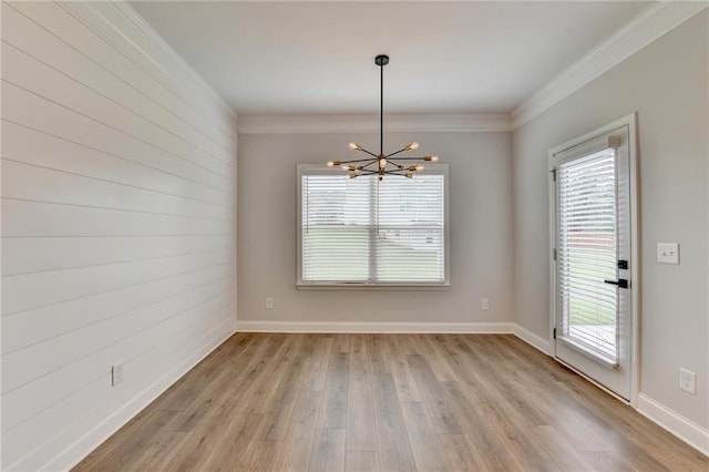 2090 Harvester Ln, Buford, GA 30518 - spare room featuring a chandelier, healthy amount of natural light, ornamental molding, and light wood-style floors