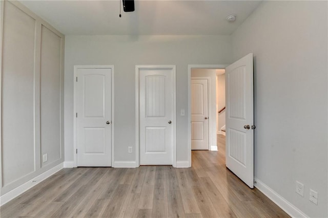 2090 Harvester Ln, Buford, GA 30518 - unfurnished bedroom featuring light wood-style floors and ceiling fan