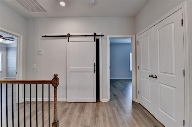 2090 Harvester Ln, Buford, GA 30518 - corridor with light wood-type flooring and a barn door