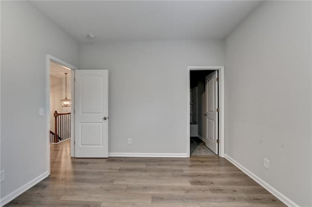 2090 Harvester Ln, Buford, GA 30518 - unfurnished bedroom featuring wood finished floors and baseboards